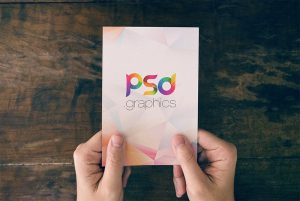 Holding Post Card in Hand Mockup   